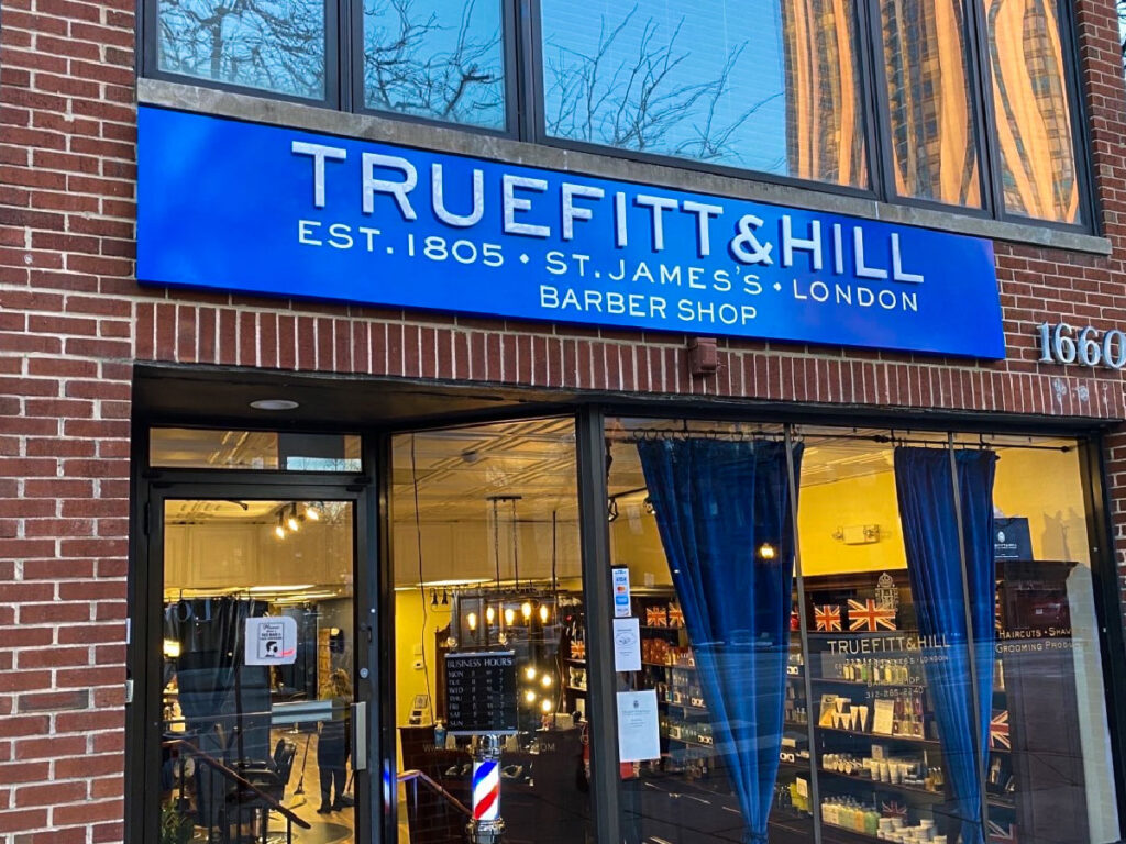 Truefitt & Hill custom sign board installed at storefront