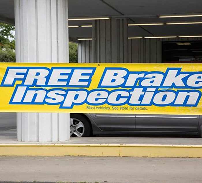 Large format vinyl banner for vehicle shop in Chicago by SignFreaks, attracting customers.